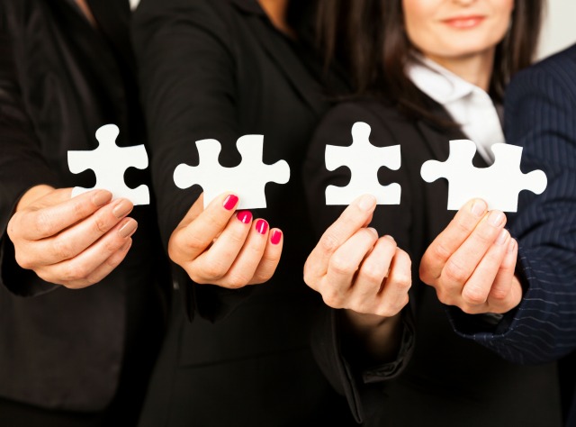 4-Business-women-holding-up-puzzle-pieces resized